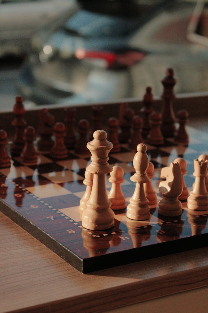 Elegant wooden chess set with strategic pieces on display in natural light.
