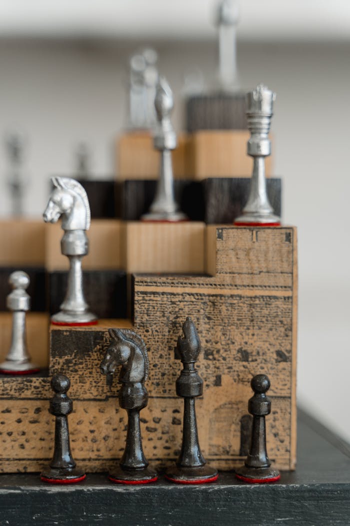 Intricate chess board with antique wooden and metal pieces, emphasizing strategic play.